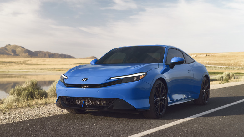 A blue Honda Prelude on a road