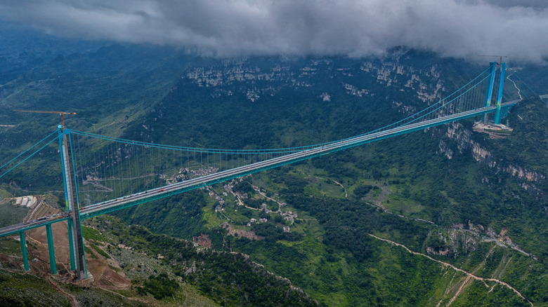 The Huajiang Grand Canyon bridge is the world's highest at 2,050 feet, and it stretches over the green, mountainous scenery of the Guizhou province in China